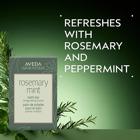 Image 2 - The image shows an Aveda Rosemary Mint bath bar package, with visible text Aveda The Art and Science of Pure Flower and Plant Essences, rosemary mint, bath bar, invigorating aroma, pain de toilette, pour le bain, arôme vivifiant, surrounded by fresh rosemary and mint sprigs against a green background, and large white text on the right stating Refreshes with Rosemary and Peppermint. Image 3 - Fresh sprigs of rosemary and mint leaves are displayed in a circle on a light green background, with text that reads Rosemary & Mint and Invigorating aroma proven to awaken the senses and improve focus. Image 4 - Several irregular, light yellow translucent flakes with dark specks are scattered on a white background. Image 5 - A stack of four light-colored soap bars, flecked with dark particles and green inclusions, sits on a reflective green surface; the top bar has white foam bubbling over it and the word AVEDA embossed, with additional text that reads HOW TO USE and Work into a lather and massage all over your body. Image 6 - Three white certification logos are displayed over a background of dark green leaves and a red plant stem; the logos read 100% VEGAN with a V, Certified B Corporation, and a leaping bunny icon with Cruelty Free International.