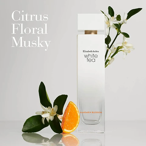 Image 1 - A bottle of Elizabeth Arden white tea perfume is positioned next to an orange slice and green leaves, with a small branch of white flowers, and the words Citrus Floral Musky and Mandarin Blossom are displayed in the upper left corner.
Image 2 - Three images arranged side by side depict the key notes of a fragrance: a green mandarin fruit on a branch, a light green orchid flower, and a cluster of vanilla orchids with vanilla pods, with the text Key Notes, Top Mandarin, Heart White Tea, Base Luminous Musk.
