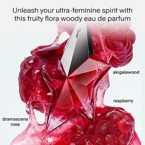 A faceted, star-shaped red perfume bottle is set amidst vibrant red, glossy liquid and whole raspberries, with the text Unleash your ultra-feminine spirit with this fruity flora woody eau de parfum, akigalawood, raspberry, and dramascena rose.